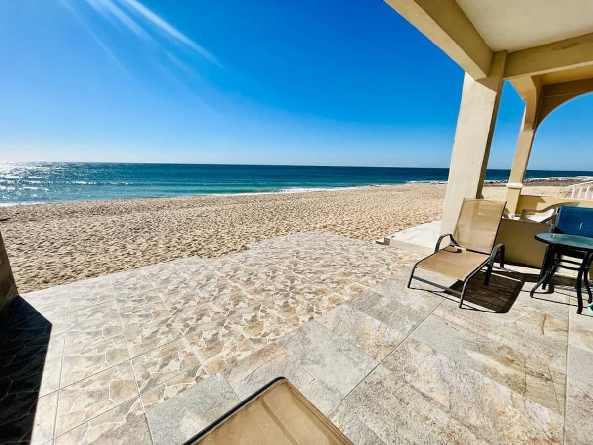 Covered oceanfront terrace and sandy beach